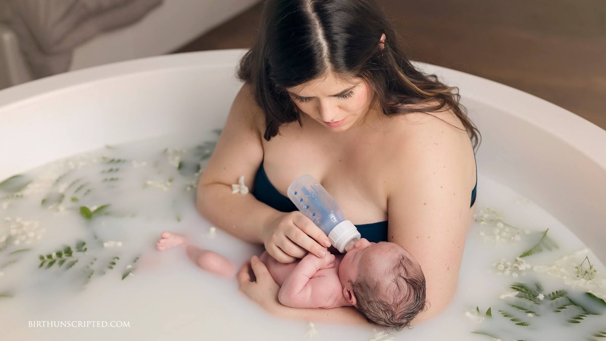 new mother bottle feeding her newborn in a milk bath
