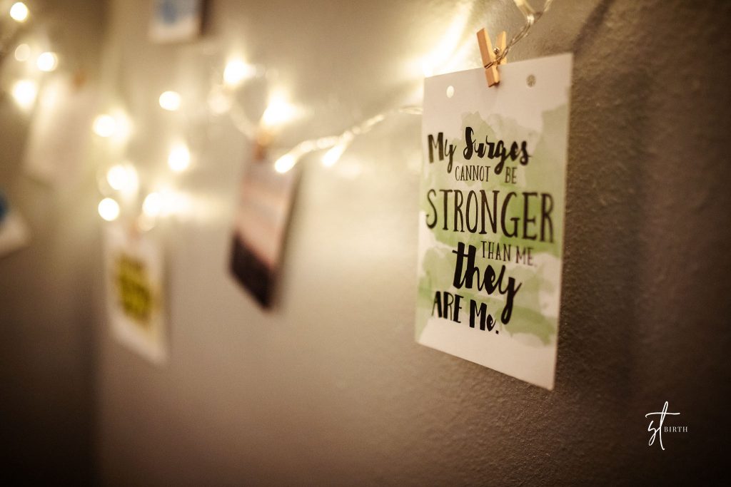 Affirmation cards strung up on the wall held by fairy lights.